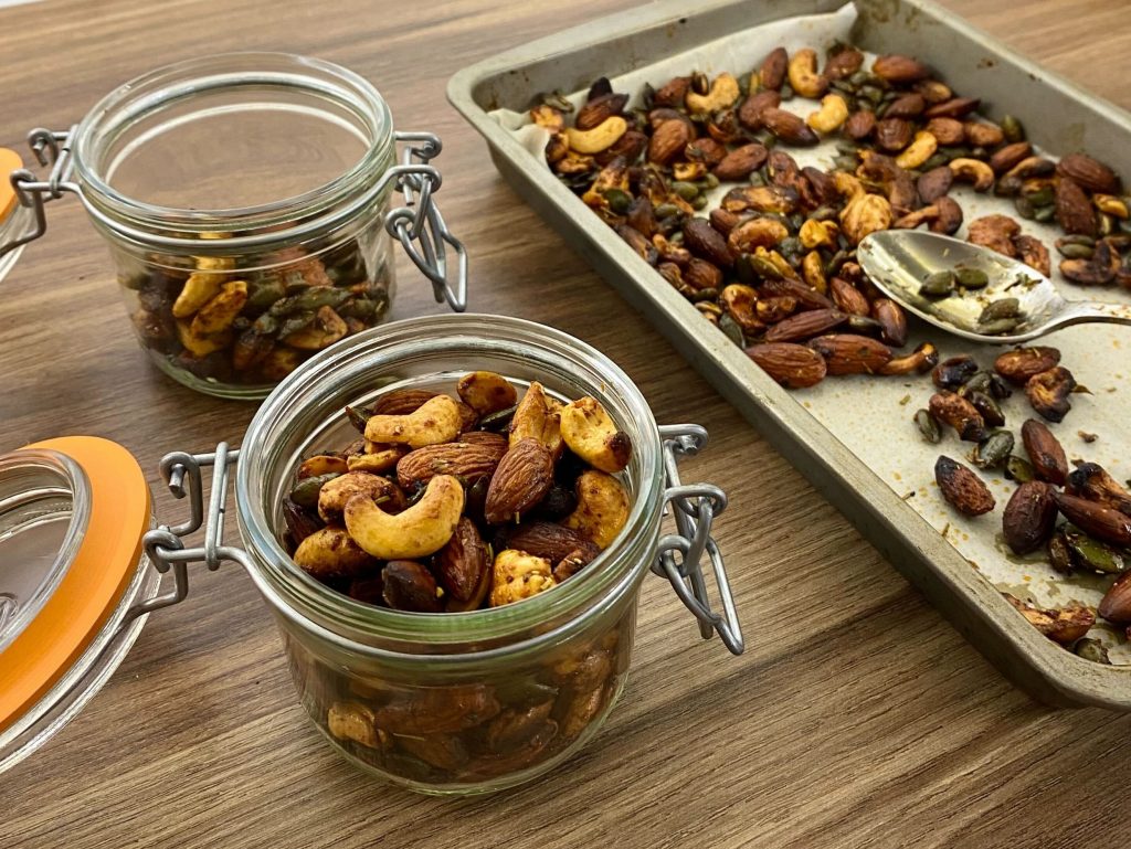 Festive roasted nuts in jars on a wooden work surface